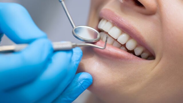 Dentist examining a patient’s teeth in the dentist.